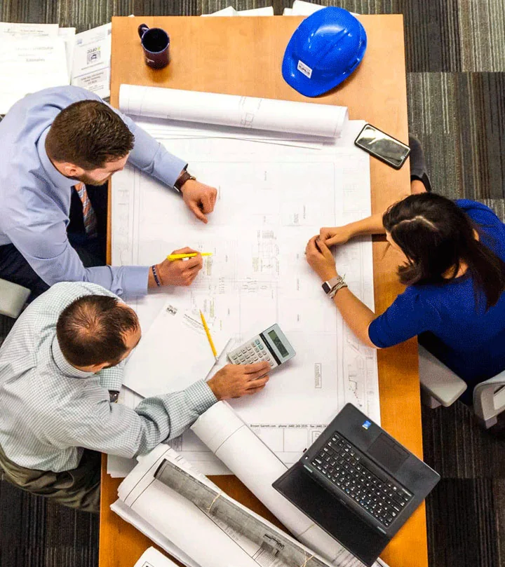 Passive House Block contact consultation with a construction team reviewing building plans
