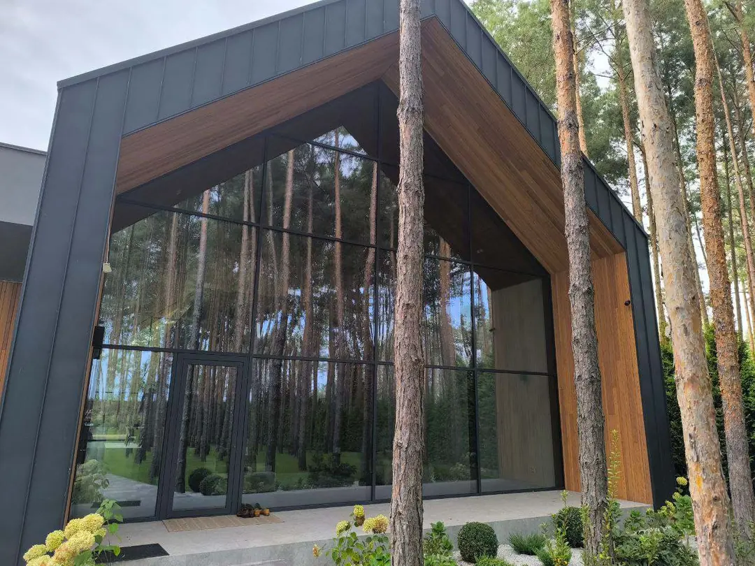 Riviera Passive House gable facade with panoramic glazing and timber soffit